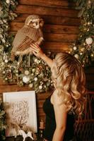 Cheerful blonde woman in the New Year decorations. Christmas time photo