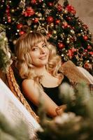 Portrait of beautiful young girl on christmas background photo