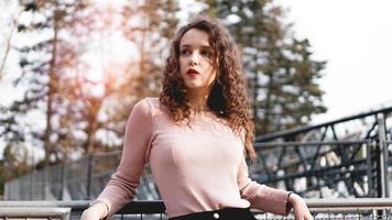 Beautiful girl on a background of a roller coaster photo