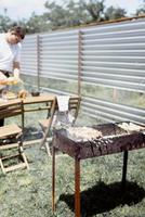 Man grilling kebabs on skewers photo