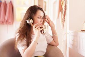 A surprised woman talks on the phone. phone handset in retro style photo