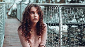 Fashion portrait of trendy young woman sitting near the netting rabitz photo