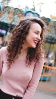 Girl chilling in amusement park in weekend morning. Laughing model photo