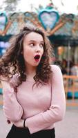 Girl chilling in amusement park in weekend morning. Laughing model photo