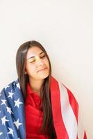 Beautiful young woman with american flag and rainbow reflection photo