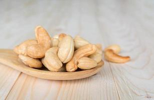 Cashews nuts on wooden spoon photo