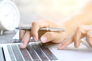 Close-up of a person working on a computer photo