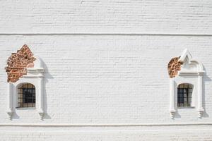 White brick wall with old windows photo