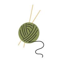 una bola verde de hilos de lana con agujas de tejer