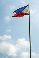 Philippines Filipino flag flying on flagpole in Manila photo