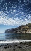 Los Gigantes cliffs natural famous landmark and volcanic black sand beach in south Tenerife island Spain photo
