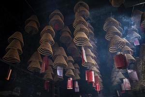 Traditional burning incense coils inside Chinese a-ma Buddhist temple in Macau China photo