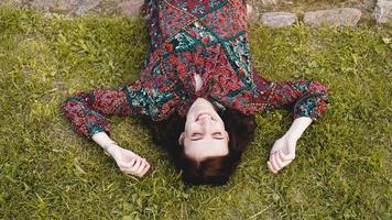 Young woman lying on grass. People relaxing in outdoors. photo