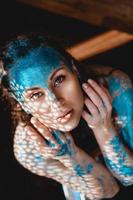 Beautiful woman with sparkles on her face. Girl with art make up photo