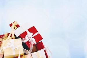 Gifts with ribbon bow on beautiful background photo