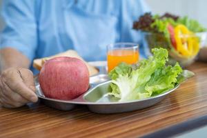 Asian senior woman patient eating breakfast photo