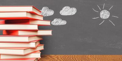 Stack of books with painted blackboard behind photo