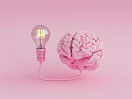 Brain connected to an illuminated light bulb photo