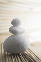 A pile of three white stones isolated in blurred background photo