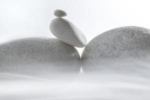 Small and big pebble white stone isolated in foggy. photo