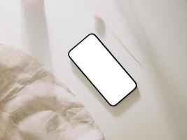 Smartphone mockup with phone with blank screen template, flat lay photo