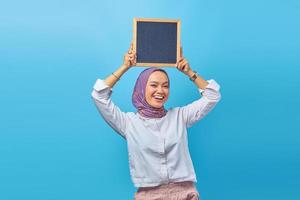 Portrait of Asian woman holding board with smiling expression photo