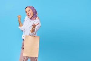 Portrait of fashionable attractive happy woman holding shopping bags photo