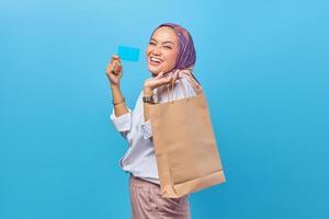 Happy pretty excited shopper showing a credit card. photo