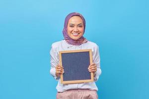 Portrait of Asian woman holding board with smiling expression photo