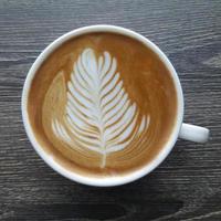 Top view of a mug of latte art coffee. photo
