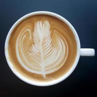 Top view of a mug of latte art coffee. photo