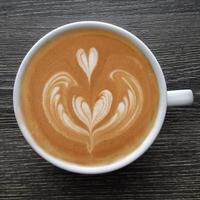 Top view of a mug of latte art coffee. photo