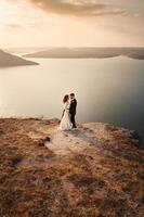 Married couple embracing on a mountain photo