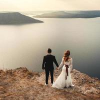 Married couple embracing on a mountain photo