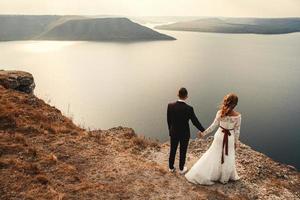 Married couple embracing on a mountain photo