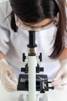 Scientist using microscope photo