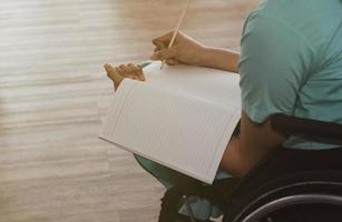 mujer trabajando y sentada en silla de ruedas foto