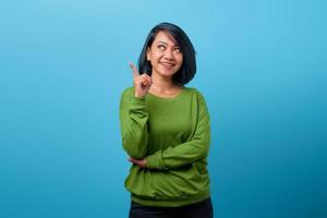 Attractive Asian woman with smile and pointing up with finger