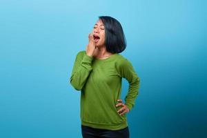 Beautiful Asian woman looking sleepiness and covering mouth with hand photo