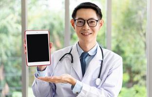 Doctor gives information by podcast via digital tablet photo