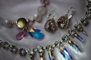 Close-up details of necklace and earrings with swarovski crystal photo