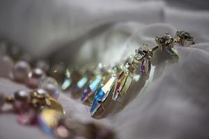 Close-up details of necklace and earrings with swarovski crystal photo