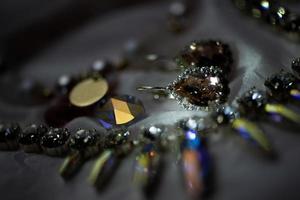 Close up details of necklace and earrings with swarovski crystal stone photo