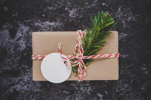 Gift boxes with small gifts on black cement photo