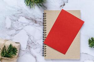 A book with red cards and Christmas tree branches photo