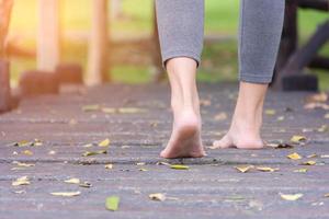 Barefoot woman in a park photo