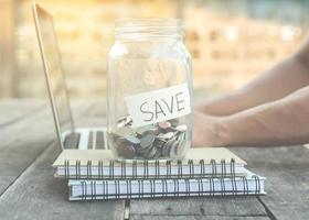 Savings jar on desk photo