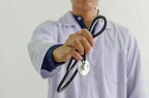 Close up of the doctor hand holding a medical stethoscope photo