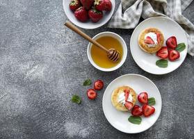 Cottage cheese pancakes, ricotta fritters on ceramic plate photo