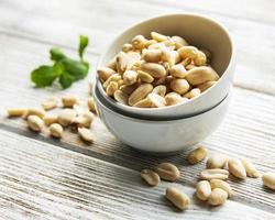 Peeled peanuts in a wooden bowl photo